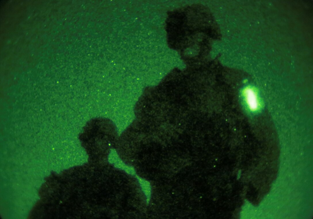 U.S. Marines with Kilo Company, Battalion Landing Team, 3rd Battalion, 1st Marine Regiment, 15th Marine Expeditionary Unit move through the terrain providing security during a simulated mechanized night raid aboard Camp Pendleton, Calif., Oct. 23, 2014. BLT 3/1 is the 15th MEU’s ground combat element. (U.S. Marine Corps photo by Cpl. Steve H. Lopez/Released)