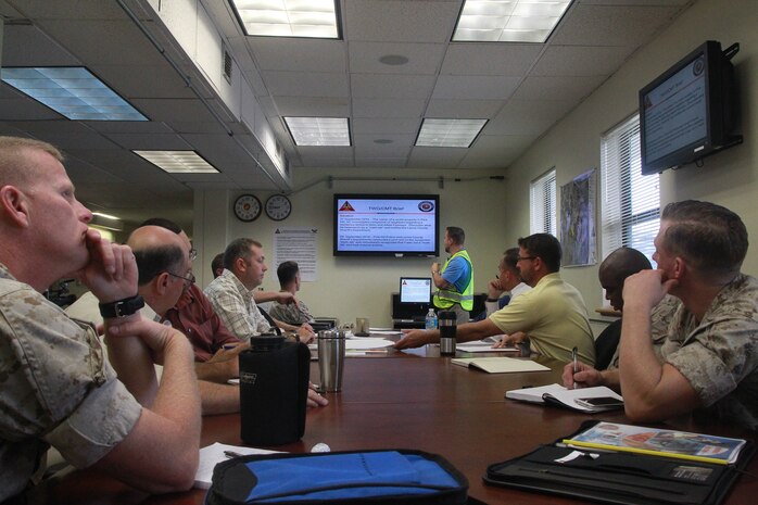 DoD personnel participate in an operations brief during Exercise Vigilant Response 2014 (VR14) aboard Marine Corps Air Station New River, N.C., Oct. 7, 2014.  VR14 is a two-day exercise designed to test the ability to conduct command and control measures in response to a pandemic outbreak aboard the Air Station.