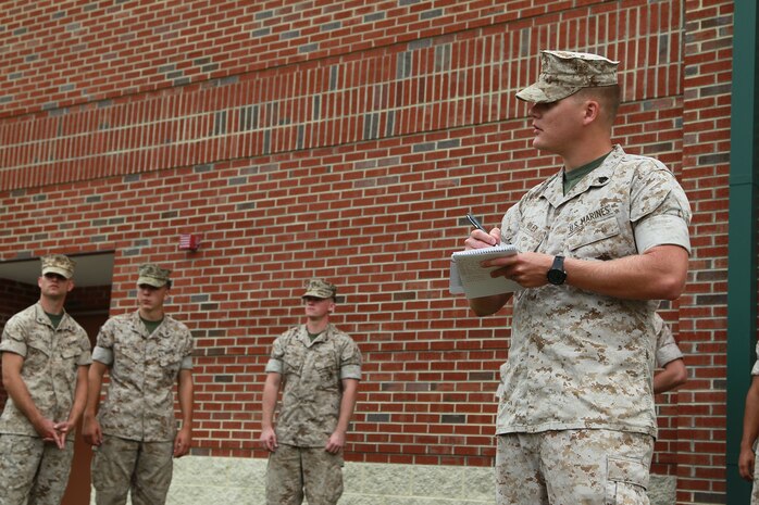 U.S. Marine Corps Sgt. Joseph C. Riley, right, noncommissioned officer in charge of the deployments section, takes accountability of his working detail during Exercise Vigilant Response 2014 (VR14) aboard Marine Corps Air Station New River, N.C., Oct. 7, 2014. VR14 is a two-day exercise designed to test the ability to conduct command and control measures in response to a pandemic outbreak aboard the Air Station.