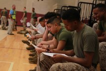 U.S. Marines complete vaccination paperwork during Exercise Vigilant Response 2014 (VR14) aboard Marine Corps Air Station New River, N.C., Oct. 7, 2014. VR14 was a two-day exercise designed to test the ability to conduct command and control measures in response to a pandemic outbreak aboard the Air Station.