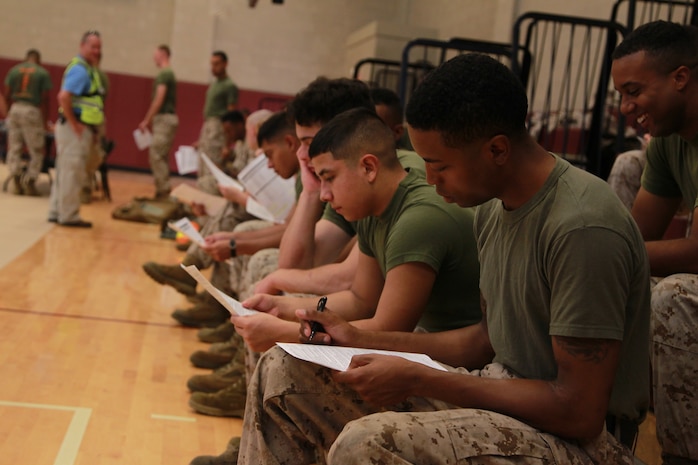 U.S. Marines complete vaccination paperwork during Exercise Vigilant Response 2014 (VR14) aboard Marine Corps Air Station New River, N.C., Oct. 7, 2014. VR14 was a two-day exercise designed to test the ability to conduct command and control measures in response to a pandemic outbreak aboard the Air Station.