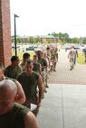 U.S. Marines wait in line for their immunization shots during Exercise Vigilant Response 2014 (VR14) aboard Marine Corps Air Station New River, N.C., Oct. 7, 2014.  VR14 was a two-day exercise designed to test the ability to conduct command and control measures in response to a pandemic outbreak aboard the Air Station.