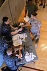U.S. Navy corpsman register Marines for influenza vaccinations during Exercise Vigilant Response 2014 (VR14) aboard Marine Corps Air Station New River, N.C., Oct. 8, 2014. VR14 was a two-day exercise designed to test the ability to conduct command and control measures in response to a pandemic outbreak.