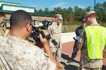 U.S. Marine Cpl. Rafael Rodriguez, combat videographer with Marine Corps Base Camp Lejeune Combat Camera, documents Marines and Sailors participating in Exercise Vigilant Response 2014 (VR14) aboard Marine Corps Air Station New River, N.C., Oct. 8, 2014. VR14 was a two-day exercise designed to test the ability to conduct command and control measures in response to a pandemic outbreak.