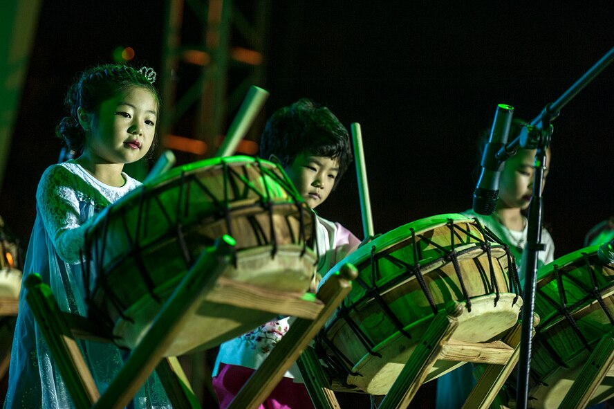 Korean children perform a traditional drum routine during the opening ceremony of the 11th Korean American Friendship Cultural Festival at the Songtan Entertainment District, Republic of Korea, Oct. 25, 2014. The festival featured musical and dance performances by Koreans and Americans. (U.S. Air Force photo by Senior Airman Matthew Lancaster)