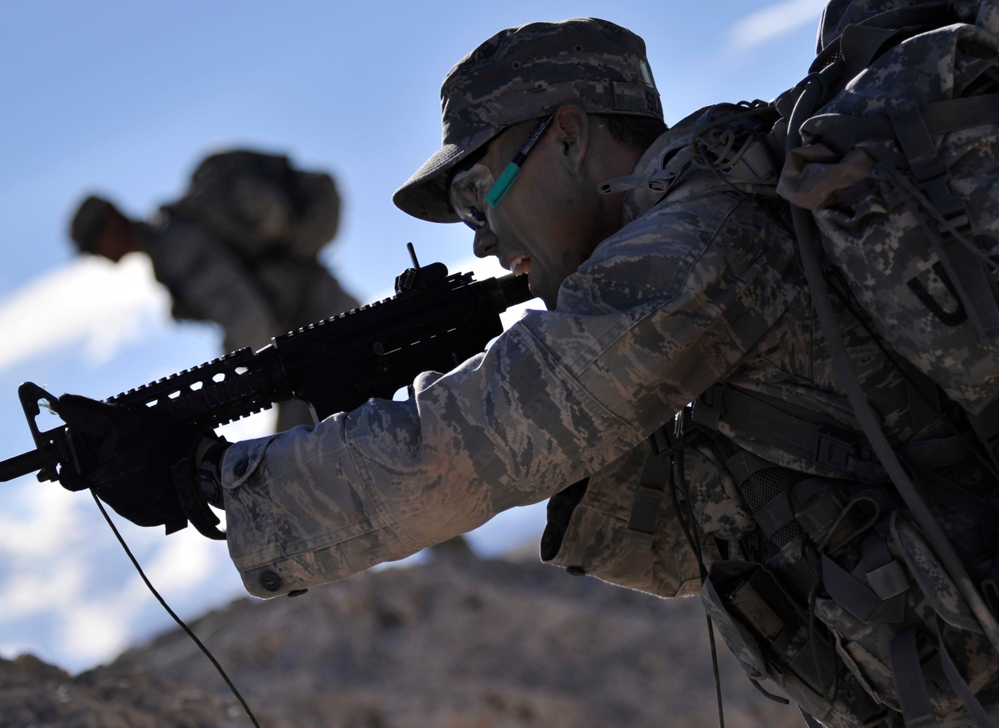 Senior Airman Franklin Sloat, 791st Missile Security Forces Squadron member, Minot Air Force Base North Dakota, returns fire to a simulated enemy ambush with blanks during a foot patrol as part of the Ranger Assessment Course Oct. 8, 2014, at Silver Flag Alpha range, Nevada. During the foot patrol the students are ambushed and must work as a team to successfully neutralize the threat and prevent friendly casualties. (U.S. Air Force photo by Airman 1st Class Christian Clausen/Released.)