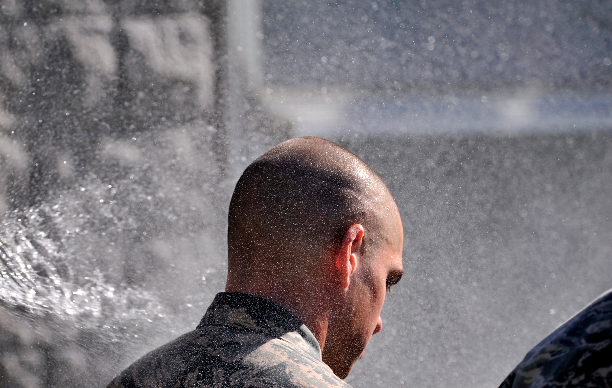 A Ranger Assessment Course student is sprayed with a hose at the municipal pool, Las Vegas, Oct. 2, 2014. After being sprayed with water, the students completed the combat water survival test, which is just one part of the RAC. Included in RAC is a physical assessment, 12-mile ruck march, classes, land navigations, weapons maintenance and employment, and foot patrol. (U.S. Air Force photo by Airman 1st Class Christian Clausen/Released)