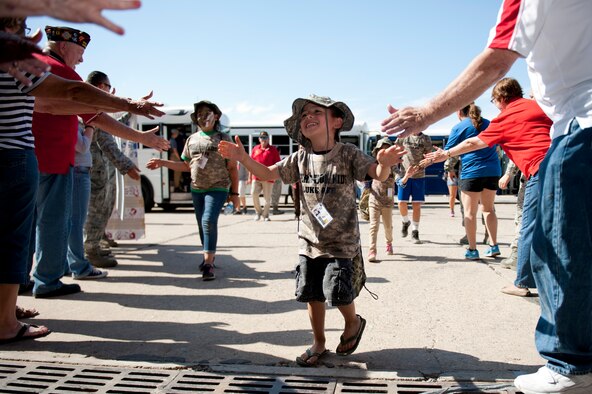 Gabriel Gutierrez, age 5, son of Staff Sgt. Arlene Gutierrez, 56th Security Force Squadron, gives high fives as he goes through the welcome home line during the sixth annual Operation Kids event at Luke Air Force Base, Arizona, Oct. 25, 2014. Operation Kids is a simulated deployed exercise for kids to help them understand the things their parents do when preparing for a deployment and what it’s like to be in a deployed environment. (U.S. Air Force photo by Staff Sgt. Staci Miller)