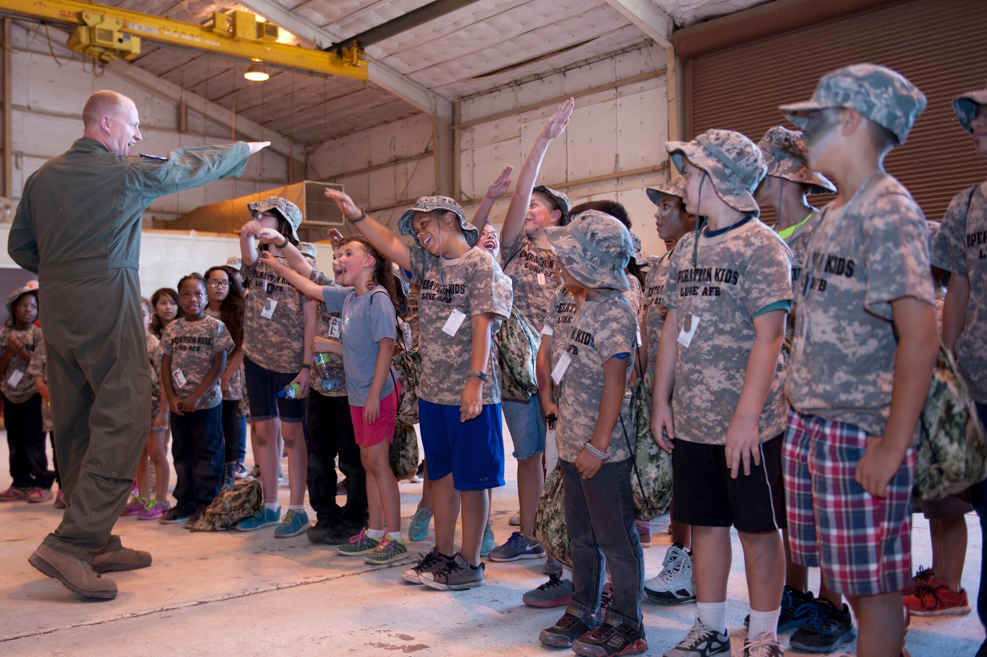 Military children show off their flight chants during the sixth annual Operation Kids event at Luke Air Force Base, Arizona, Oct. 25, 2014. Operation Kids is a simulated deployed exercise for kids to help them understand the things their parents do when preparing for a deployment and what it’s like to be in a deployed environment. (U.S. Air Force photo by Staff Sgt. Staci Miller)