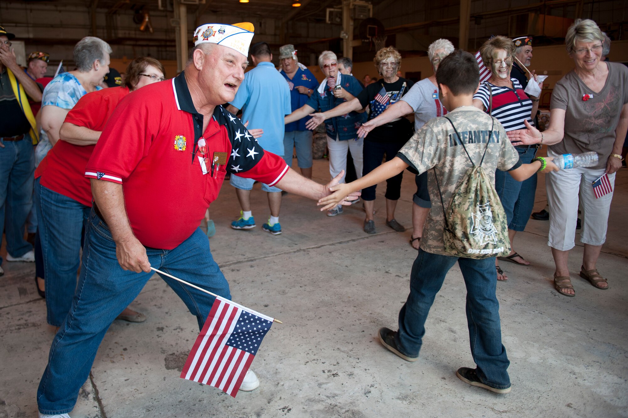 Veterans of Foreign Wars, United Service Organization and members of the community greet "welcome home" military children during the sixth annual Operation Kids event at Luke Air Force Base, Arizona, Oct. 25, 2014. Operation Kids is a simulated deployed exercise for kids to help them understand the things their parents do when preparing for a deployment and what it’s like to be in a deployed environment. (U.S. Air Force photo by Staff Sgt. Staci Miller)