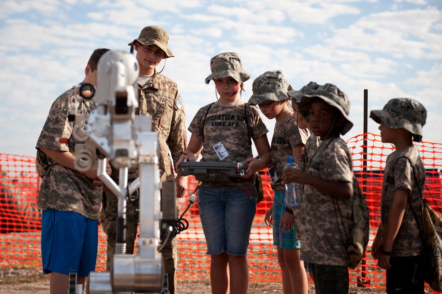 Brianna Sutton, age 10, daughter of Tech. Sgt Stanley Sutton, 56th Logistics Readiness Squadron, controls a explosive ordnance disposal robot during the sixth annual Operation Kids event at Luke Air Force Base, Arizona, Oct. 25, 2014. Operation Kids is a simulated deployed exercise for kids to help them understand the things their parents do when preparing for a deployment and what it’s like to be in a deployed environment. (U.S. Air Force photo by Staff Sgt. Staci Miller)