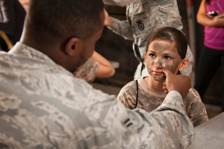 Anissa Burgard, age 11, daughter of Master Sgt. Craig Burgard, 310th Aircraft Maintenance Unit, gets her face painted during the sixth annual Operation Kids event at Luke Air Force Base, Arizona, Oct. 25, 2014. Operation Kids is a simulated deployed exercise for kids to help them understand the things their parents do when preparing for a deployment and what it’s like to be in a deployed environment. (U.S. Air Force photo by Staff Sgt. Staci Miller)