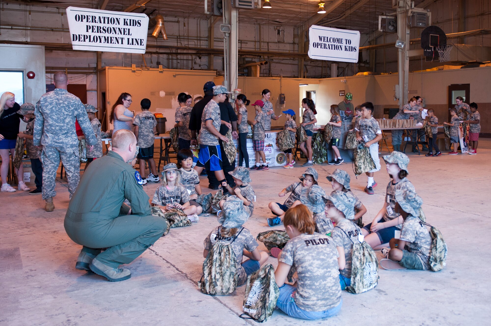 Military children go through a simulated mobility line where they received uniforms, identification cards and dog-tags during the sixth annual Operation Kids event at Luke Air Force Base, Arizona, Oct. 25, 2014. Operation Kids is a simulated deployed exercise for kids to help them understand the things their parents do when preparing for a deployment and what it’s like to be in a deployed environment. (U.S. Air Force photo by Staff Sgt. Staci Miller)