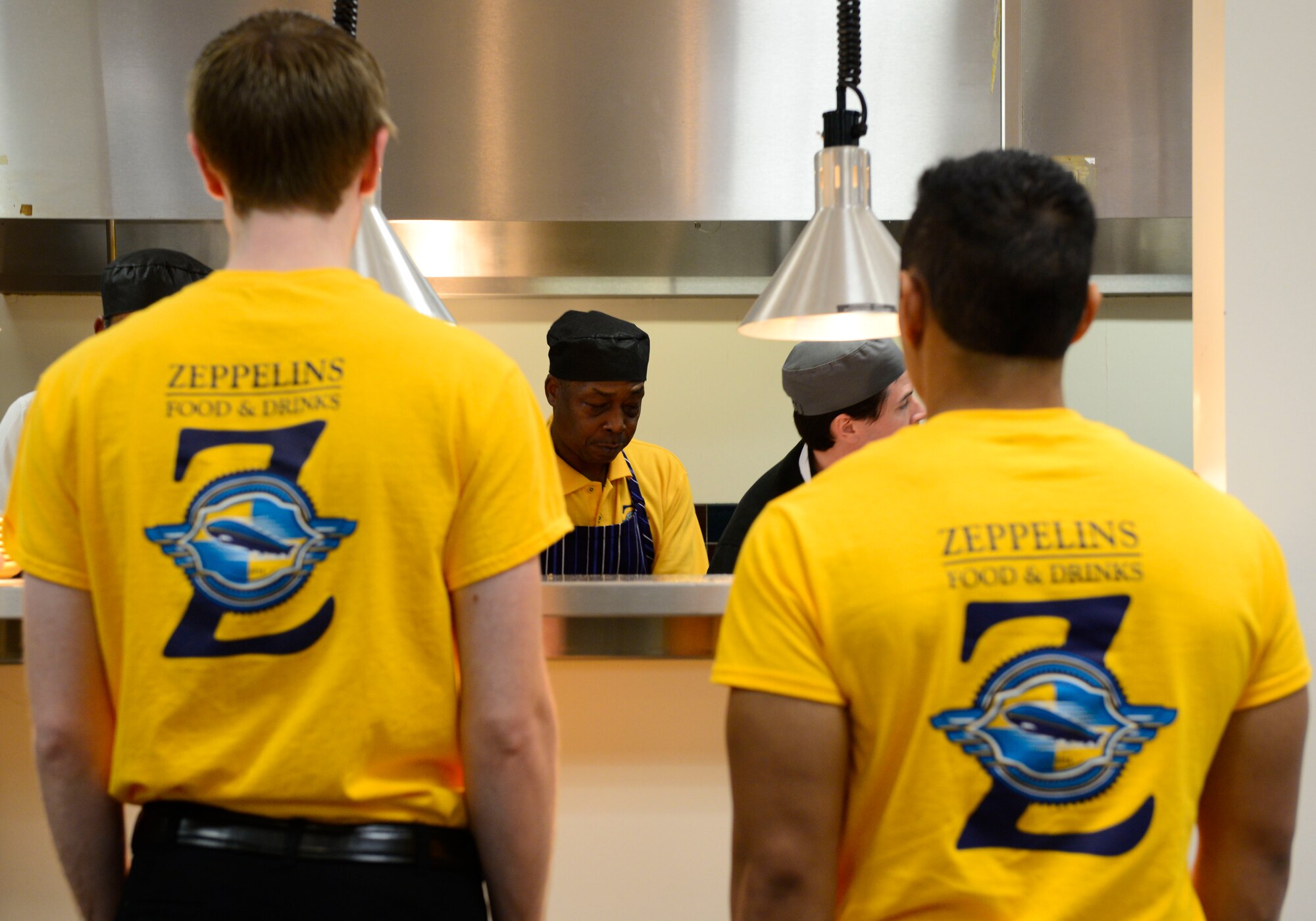 Waiters wait while the chefs prepare orders during the grand opening of Scott Air Force Base’s new resturant, Zeppelins. (U.S. Air Force photo/ Staff Sgt. Stephenie Wade)