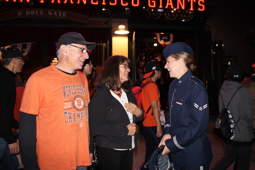 Airman 1st Class Michelle Doolittle, U.S. Air Force Band of the Golden West vocalist, interacts with fans after Game Five of the World Series Oct. 26, 2014, in San Francisco, California. Doolittle sang "God Bless America" during the seventh-inning stretch of the World Series game. (U.S. Air Force photo by Staff Sgt. Megan May)