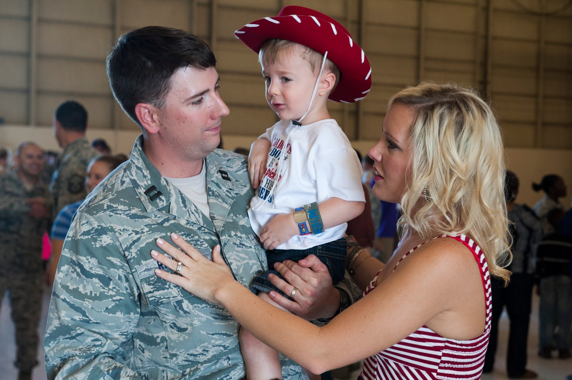U.S. Air Force Capt. Jonathan Randall, 824th Base Defense Squadron flight commander, reunites with his family after a deployment Oct. 26, 2014, at Moody Air Force Base, Ga. Randall, along with other members from the 824th BDS, returned from a six-month deployment to Southwest Asia.
(U.S. Air Force photo by Airman 1st Class Dillian Bamman/Released)
