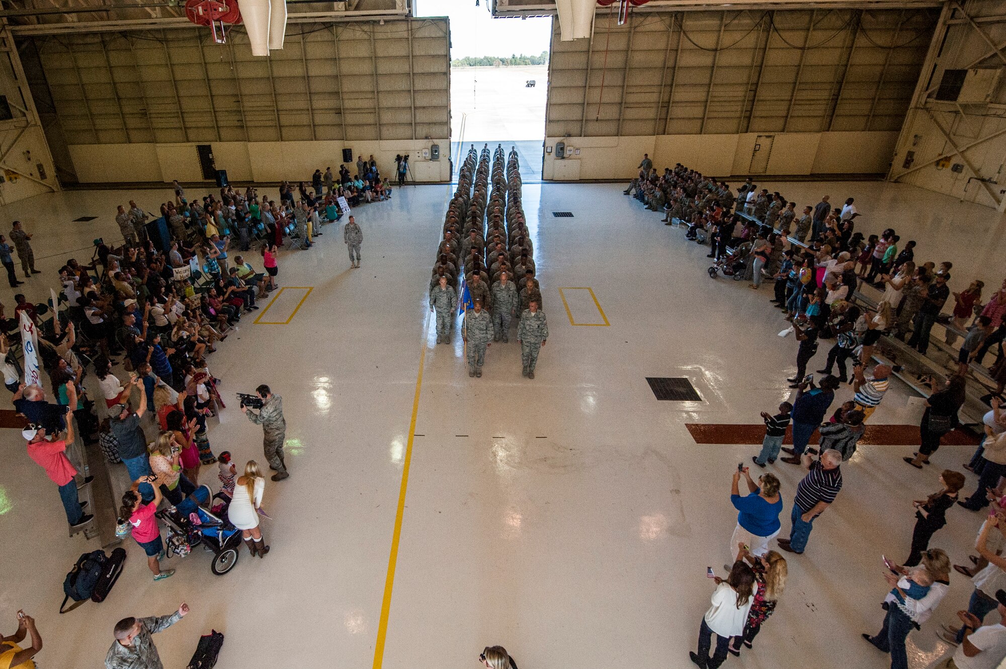 Family, friends and coworkers cheer on 824th Base Defense Squadron Airmen returning from a deployment Oct. 26, 2014, at Moody Air Force Base, Ga. More than 100 Airmen from the 824th BDS returned to Moody after a six-month deployment to Southwest Asia. (U.S. Air Force photo by Airman 1st Class Dillian Bamman/Released)