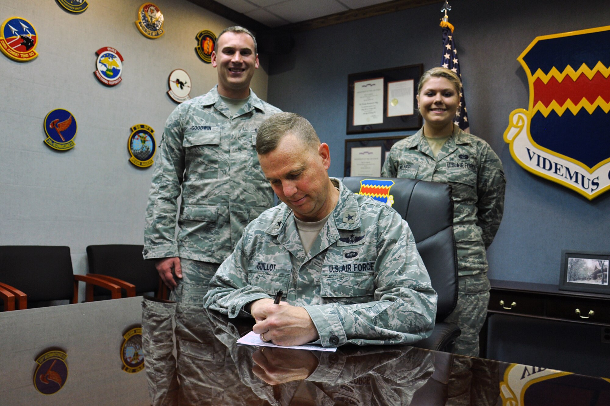 U.S. Air Force Brig. Gen. Gregory Guillot, 55th Wing commander, signs a 2014 Combined Federal Campaign donor pamphlet on Offutt Air Force Base, Nebraska, Oct.  23. The CFC is the world’s largest and most successful annual workplace charity campaign with almost 200 CFC campaigns throughout the country and overseas raising millions of dollars each year. (U.S. Air Force photo by Charles Haymond/Released) 