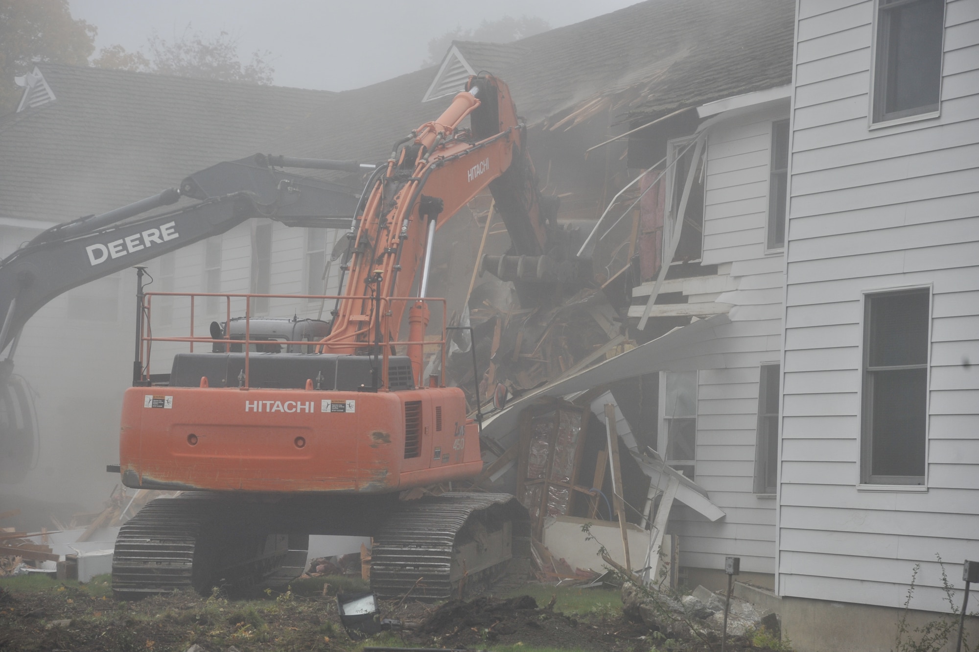 Contractors demolish the previous installation headquarters building, also known as the "White House," Oct. 27, 2014, at Fairchild Air Force Base, Wash. The building was built in 1943 and has served 10 units ranging from major commands, bomb wings and refueling wings, as well as subordinate and tenant units. (U.S. Air Force photo/Senior Airman Mary O'Dell)