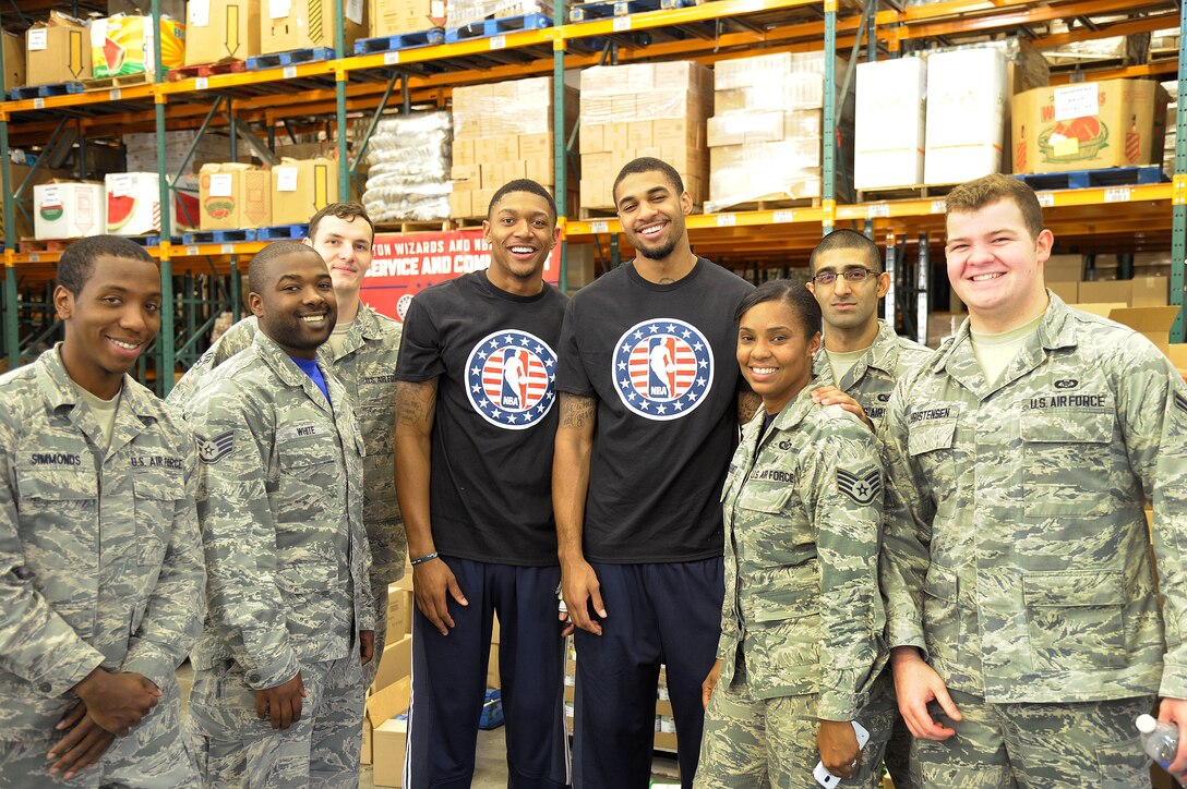 Airmen from Air Force District of Washington spent the afternoon at the Capital Area Food Bank in Washington, D.C., packing bags with members of the Washington Wizards as part of the NBA’s Commitment to Service initiative Oct. 24, 2014. The initiative focuses on building a culture of service by meeting local needs through community service projects done jointly between NBA teams and the U.S. military. (U.S. Air Force photo/ Mike Martin)