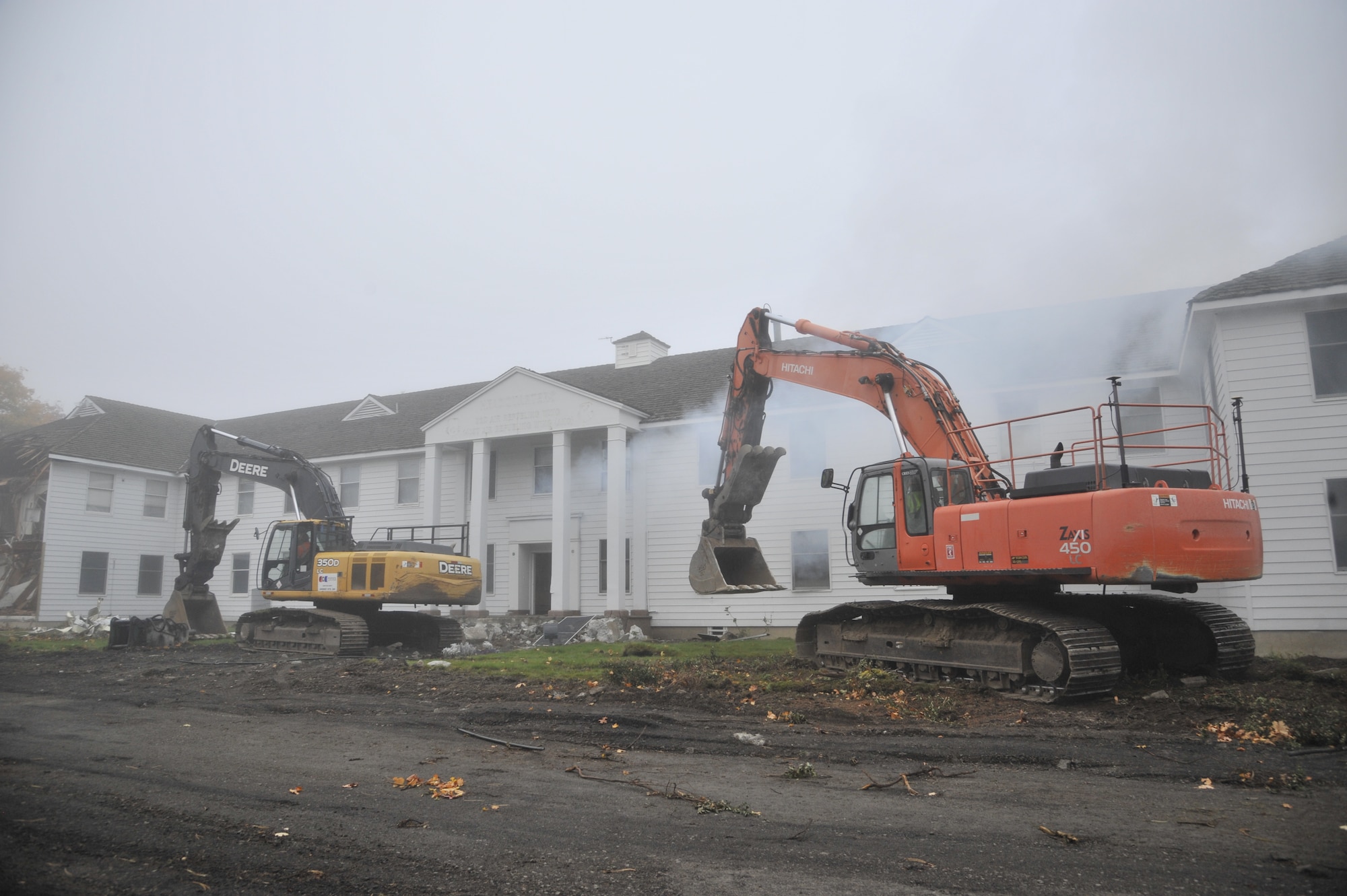 Contractors prepare to begin demolition on the previous installation headquarters building, also known as the "White House," Oct. 27, 2014, at Fairchild Air Force Base, Wash. The building was built in 1943 and has served 10 units ranging from major commands, bomb wings and refueling wings, as well as subordinate and tenant units. (U.S. Air Force photo/Senior Airman Mary O'Dell)