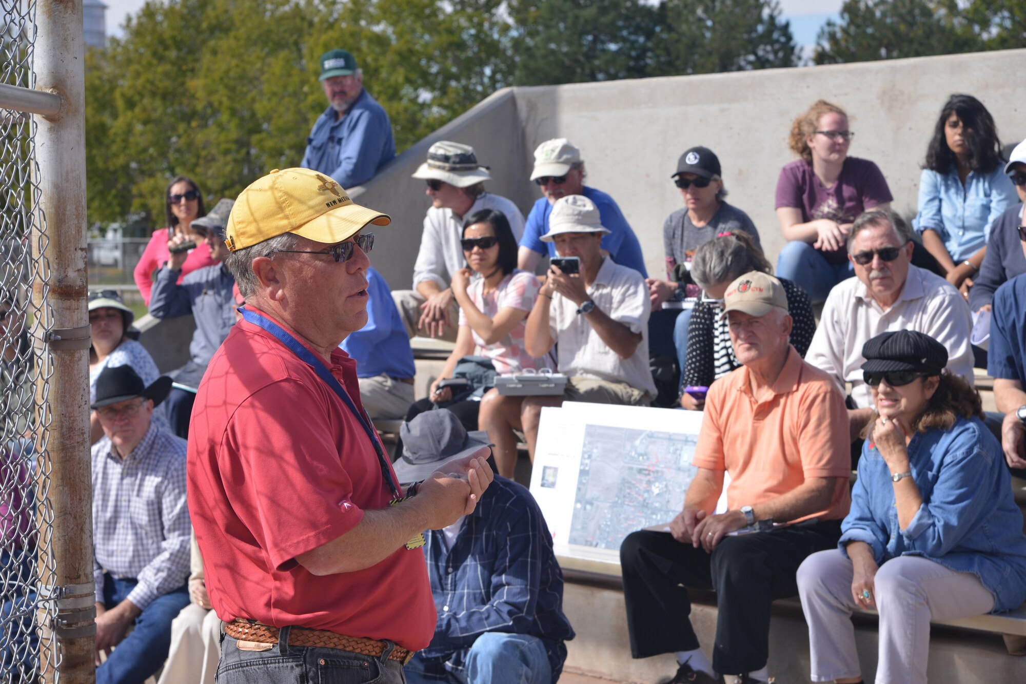 Wayne Bitner, chief of environmental restoration for Kirtland's Installation Support Team (Air Force Civil Engineer Center), speaks to community members, geologists and hydrologists near the site of the Kirtland Air Force Base fuel spill during a field trip Oct. 21. Bitner discussed the base's remediation efforts, including soil vapor extraction, where fuel vapor is drawn from purpose-built wells near where the fuel leaked into the ground. The group made two other stops, one at Montessa Park to discuss the general geology of the Rio Grande Basin, and one at Chavez Community Center, where three monitoring wells have been drilled. Among those who participated in the field trip were professionals from the New Mexico Environment Department, U.S. Geological Survey, New Mexico Bureau of Geology, Albuquerque Bernalillo County Water Utility Authority, U.S. Air Force, Air Force Civil Engineering Center and CB&I. (Photo by Todd Berenger)
