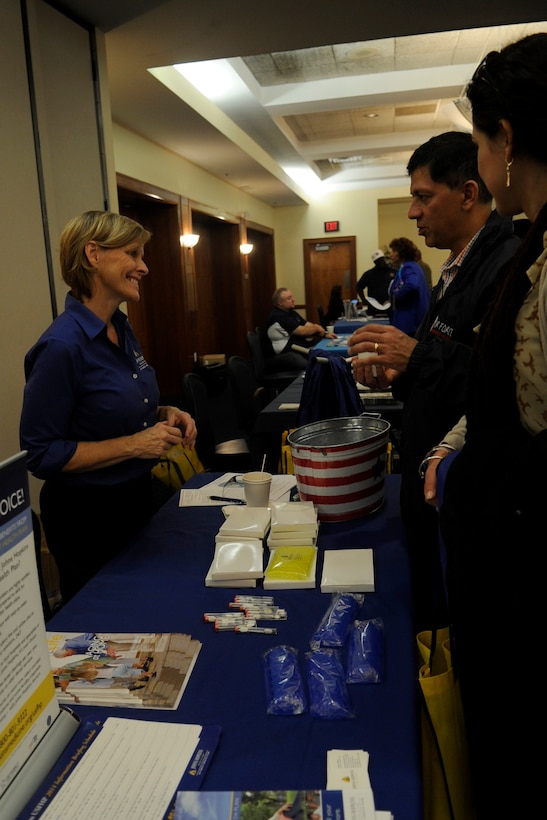 Katrina Teford, John Hopkins U.S. Family Health Plan field services representative, speaks with customers during the Joint Bases Andrews and Anacostia-Bolling Retiree Appreciation Day at The Club on JBA, Maryland, Oct. 25, 2014. The event featured a health fair, legal and causality assistance, Space-A Travel briefings and identification card renewals. For more information on benefits available to retirees visit the Retiree Activities Office at Andrews in Building 1604. (U.S. Air Force photo/ Senior Airman Nesha Humes)