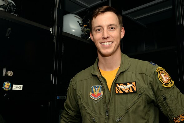 U.S. Air Force Capt. Stephen Grace, 79th Fighter Squadron fighter pilot, stands by his locker in the 79th FS locker room at Shaw Air Force Base, S.C., Oct. 3, 2014. Grace, an Air Force Academy, Colorado Springs, Colo., graduate, attributes his ongoing success in the Air Force to his competitiveness developed from his swimming career. (U.S. Air Force photo by Airman 1st Class Jonathan Bass/Released)