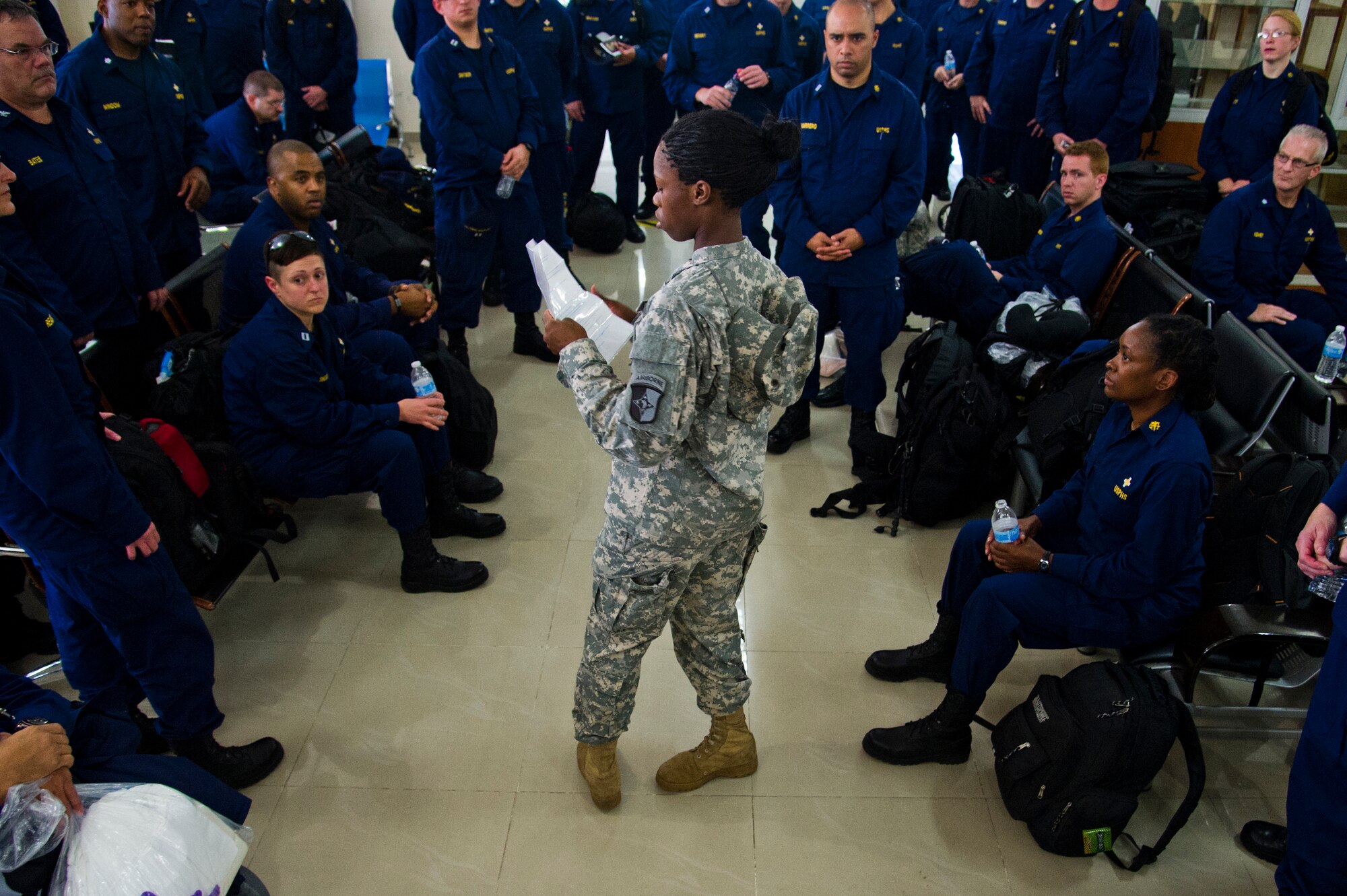 ROBERTS INTERNATIONAL AIRPORT, Republic of Liberia - Members of the U.S. Public Health Service are briefed upon arrival by a member of the U.S. Army's 101st Airborne Division here, during Operation UNITED ASSISTANCE, October 27, 2014. The medical staff of the USPHS will aid Ebola patient medical staff who need medical care. OUA is a U.S. Africa Command-led operation to provide command and control, logistics, training and engineering support to the U.S. government’s efforts to contain the Ebola virus outbreak in West African nations. (U.S. Air Force photo/Staff Sgt. Gustavo Gonzalez/RELEASED)