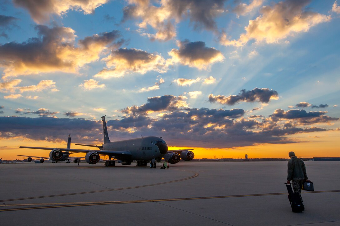 A lone 108th Wing maintenance Airman heads toward a KC-135R Stratotanker on the New Jersey Air National Guard flight line at Joint Base McGuire-Dix-Lakehurst, N.J., Sept. 26, 2014. (U.S. Air National Guard photo by Master Sgt. Mark C. Olsen/Released)