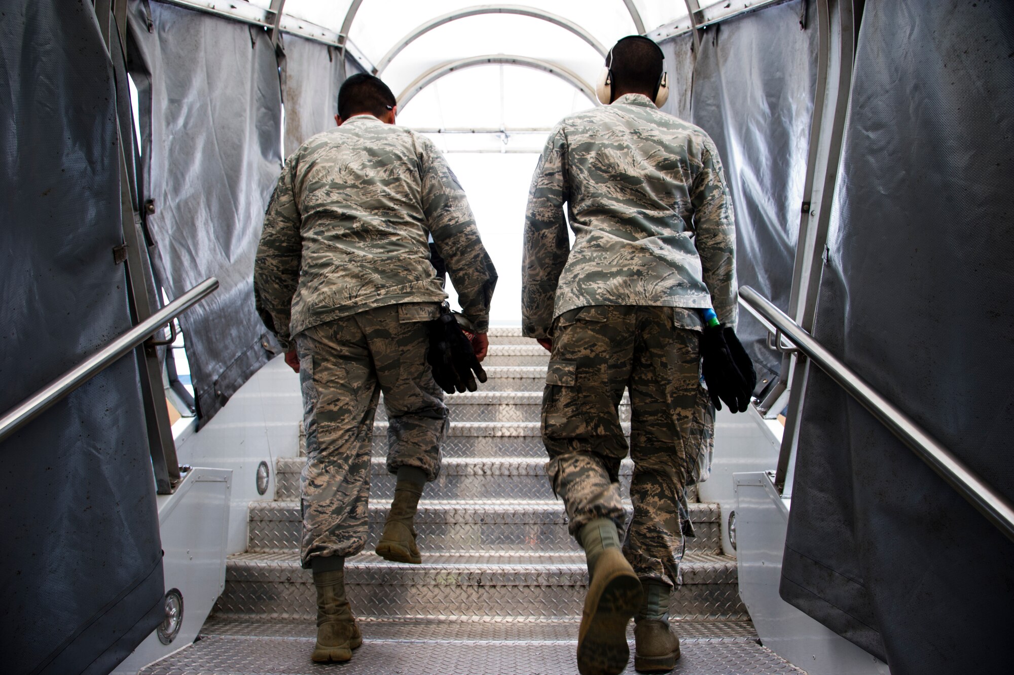 ROBERTS INTERNATIONAL AIRPORT, Republic of Liberia - U.S. Air Force Staff Sgt. Daniel Gonzalez and Staff Sgt. Robert Higginbotham, both aerial porters with the Joint Task Force-Port Opening team of the 621st Contingency Response Wing stationed at Joint Base McGuire-Dix-Lakehurst, N.J., walk up passenger air stairs on their way to brief members of the U.S. Public Health Service after arriving here, during Operation UNITED ASSISTANCE, October 27, 2014. The medical staff of the USPHS will aid Ebola patient medical staff who need medical care. OUA is a U.S. Africa Command-led operation to provide command and control, logistics, training and engineering support to the U.S. government’s efforts to contain the Ebola virus outbreak in West African nations. (U.S. Air Force photo/Staff Sgt. Gustavo Gonzalez/RELEASED)