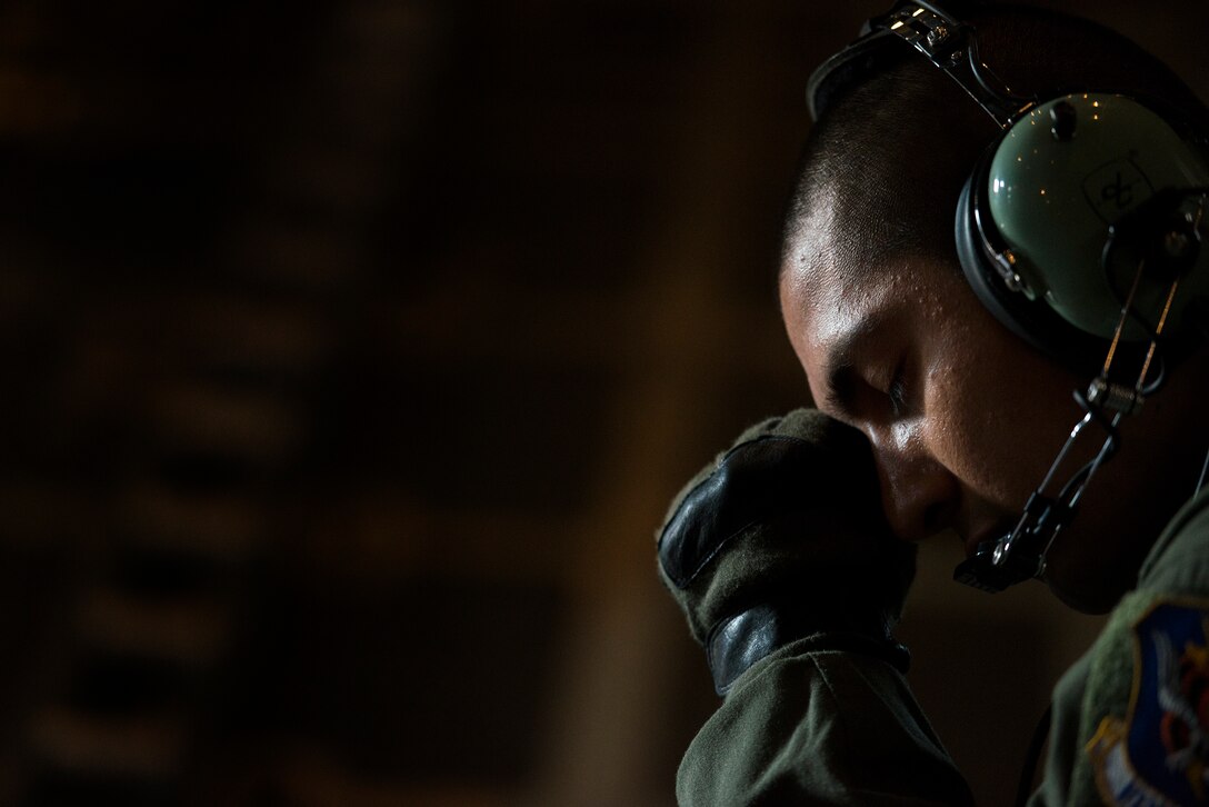 U.S. Air Force Senior Airman Edgar Perez, 71st Rescue Squadron loadmaster, rests his eyes after his turn scanning the valley floor in search of a downed Air National Guard F-15C Eagle pilot Aug. 28, 2014, in the skies over the Shenandoah Valley, Va. Crewmembers aboard an HC-130P Combat King scanned in 30-minute shifts to keep their eyes fresh. (U.S. Air Force photo by Airman 1st Class Ryan Callaghan/Released)