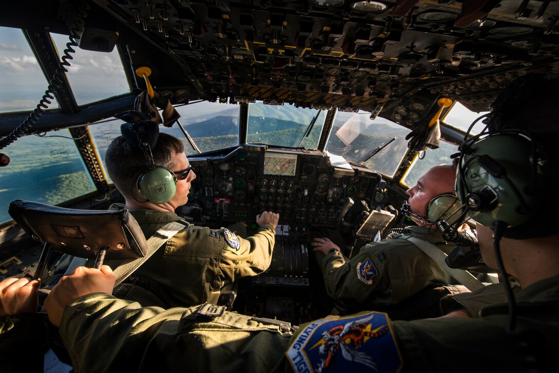 Crewmembers from the 71st Rescue Squadron discuss search patterns in an HC-130P Combat King during the search for a downed Air National Guard F-15C Eagle pilot Aug. 28, 2014, over the Shenandoah Valley, Va. The 14-man crew scanned the valley floor for six hours before returning to Moody Air Force Base, Ga., for refueling and a new crew. (U.S. Air Force photo by Airman 1st Class Ryan Callaghan/Released)