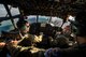 Crewmembers from the 71st Rescue Squadron discuss search patterns in an HC-130P Combat King during the search for a downed Air National Guard F-15C Eagle pilot Aug. 28, 2014, over the Shenandoah Valley, Va. The 14-man crew scanned the valley floor for six hours before returning to Moody Air Force Base, Ga., for refueling and a new crew. (U.S. Air Force photo by Airman 1st Class Ryan Callaghan/Released)