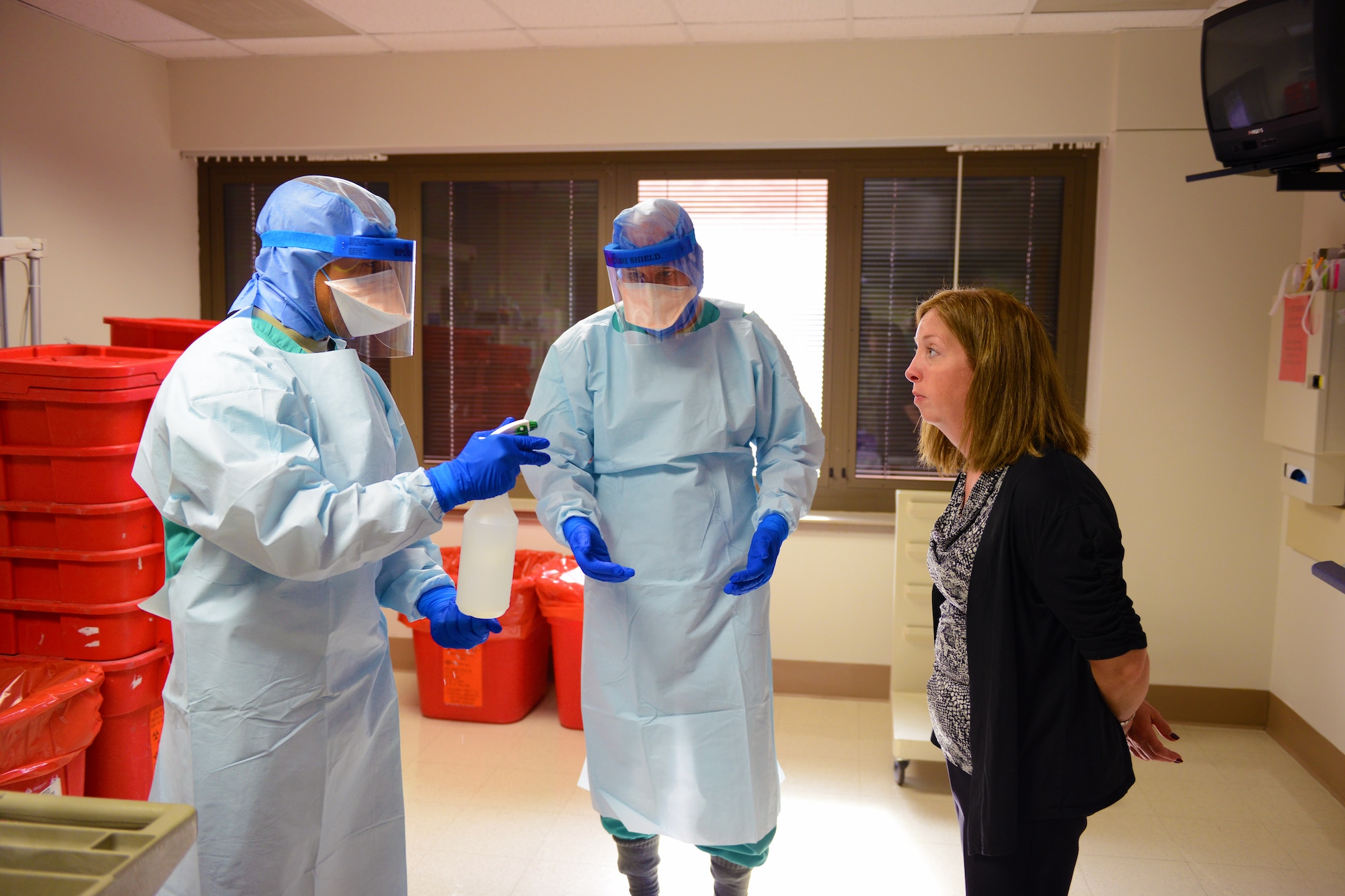 Kristie Yeakle, right, bio safety officer,, evaluates two students as they sanitize their personal protective equipment during training at the San Antonio Military Medical Center in San Antonio, Texas, Oct. 24, 2014. The students are part of a 30-person team designated for “prepare to deploy” status in the event of an Ebola crisis in the U.S. (DoD photo/Army Sgt. 1st Class Tyrone C. Marshall Jr.)
