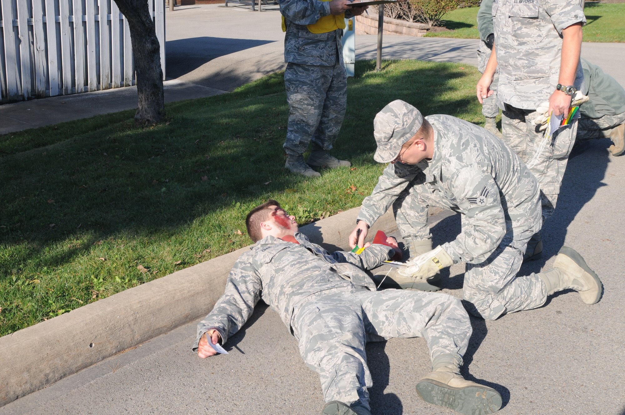 Senior Airman John Wagner Jr., a medical technician for the 910th Medical Squadron, fills out a triage tag for a wounded Airman during a natural disaster response exercise here , Oct. 5, 2014. The exercise was intended to hone emergency reaction and response skills for base personnel. U.S. Air Force photo/Tech. Sgt. Rick Lisum.