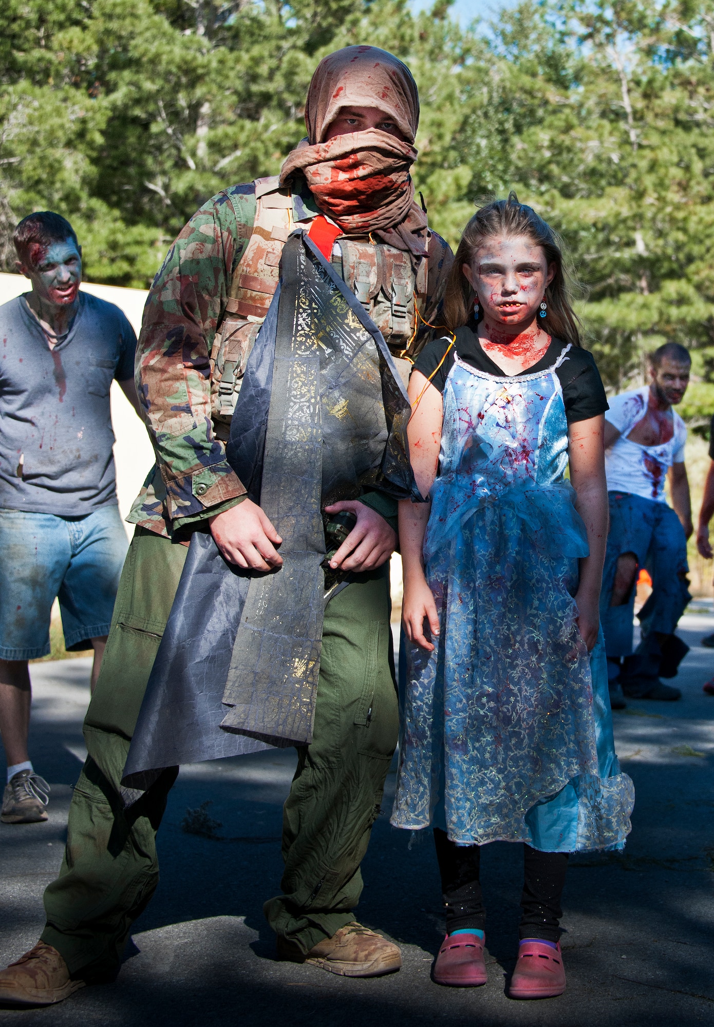 A zombie bomber and child were among the many undead attackers the runners had to escape during the annual Zombie Stomp event Oct. 25 at Eglin Air Force Base, Fla.  More than 100 people attempted to outrun zombies and maneuver through various obstacles along the four-mile course. (U.S. Air Force photo/Samuel King Jr.)