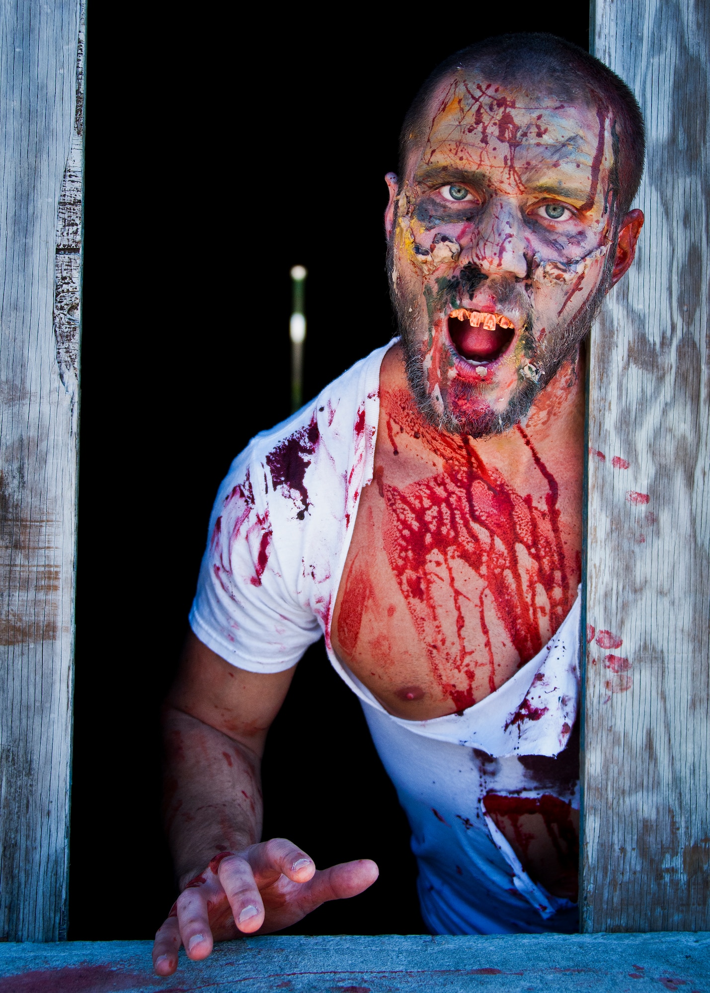 A zombie hangs out of a window at base tango during the annual Zombie Stomp event Oct. 25 at Eglin Air Force Base, Fla.  More than 100 people attempted to outrun zombies and maneuver through various obstacles along the four-mile course. (U.S. Air Force photo/Samuel King Jr.)