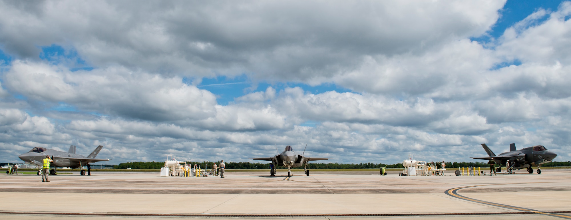 Air Force and Marine F-35 Lightning II variants receive fuel in the hot pit areas of the 33rd Fighter Wing flightline at Eglin Air Force Base, Fla.  All of the F-35 variants use the refueling areas in conjunction with the 96th Logistics Readiness Squadron’s fuels flight. (U.S. Air Force photo/Samuel King Jr.)