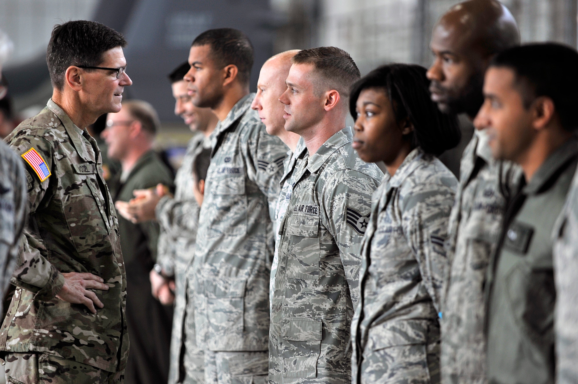 U.S. Army Gen. Joseph Votel, U.S. Special Operations Command commander, takes a moment to greet Air Commandos before a town hall meeting Oct. 23, 2014, in Hangar 539 on RAF Mildenhall, England. During the meeting, Votel acknowledged the 352nd Special Operations Group for its robust posture and continuous support on a variety of contingencies. (U.S. Air Force photo by Senior Airman Christine Griffiths/Released)