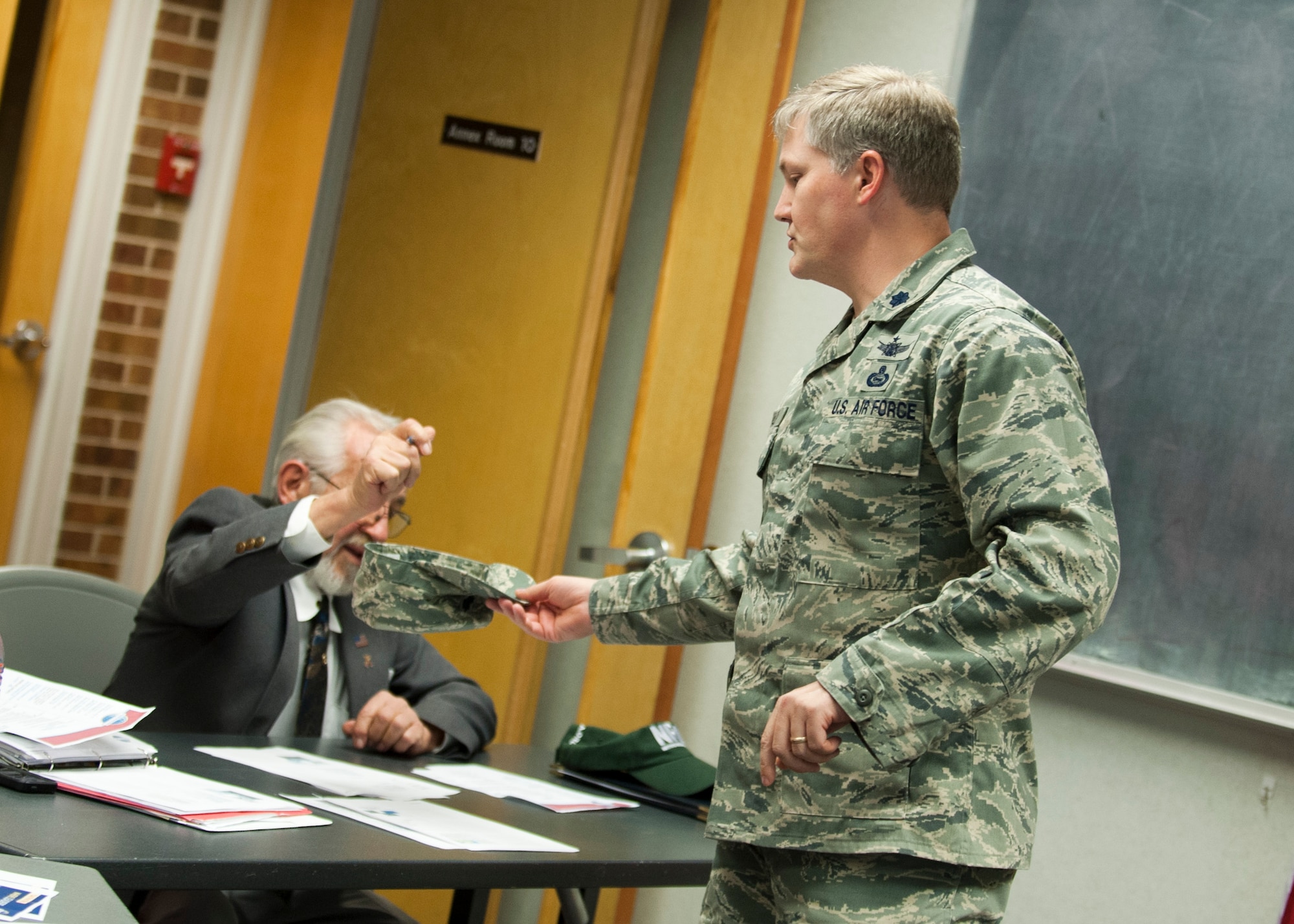 PETERSON AIR FORCE BASE, Colo. – Lt. Col. Kevin Whaley, Peterson AFB Toastmaster chapter president, collects names to be drawn for an impromptu speech at the base chapel Oct 21. Toastmasters is an organization with more than 313,000 members in 126 countries helping its members improve and master the skill of public speaking. (U.S. Air Force photo/Staff Sgt. Aaron Breeden)
