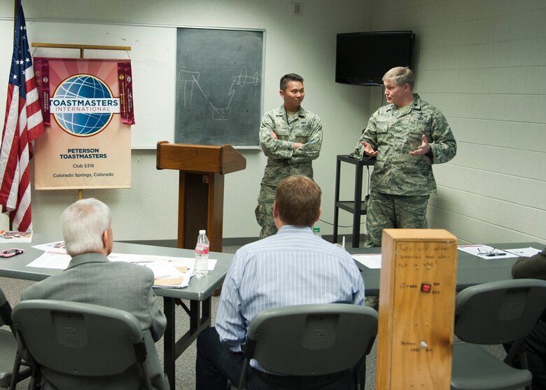 PETERSON AIR FORCE BASE, Colo. – 1st Lt. Vinh Le (left), Air Force Space Command A8 assistant executive officer, prepares for an impromptu speech, the topic of which was chosen by Lt. Col. Kevin Whaley (right), Peterson AFB Toastmaster chapter president, at the base chapel Oct. 21. Toastmasters is an organization with more than 313,000 members in 126 countries helping its members improve and master the skill of public speaking. (U.S. Air Force photo/Staff Sgt. Aaron Breeden)