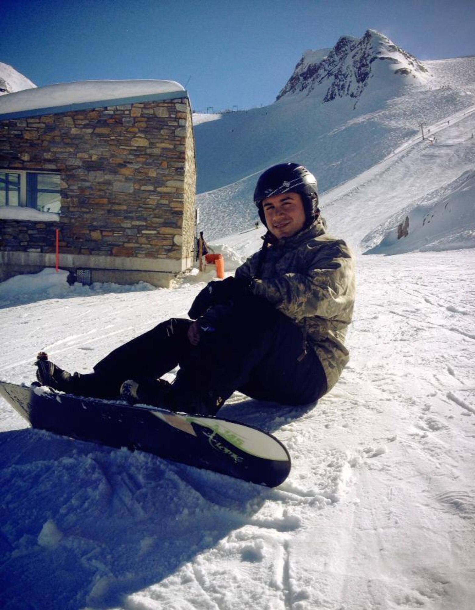 Senior Airman Giovanni Pinzon, a former 86th Ammunitions Squadron conventional maintenance crew chief, relaxes at the peak of a slope during a snowboarding trip to the Alps in 2013. Pinzon is an advocate of frequent travels as a way to increase morale. (Courtesy photo)