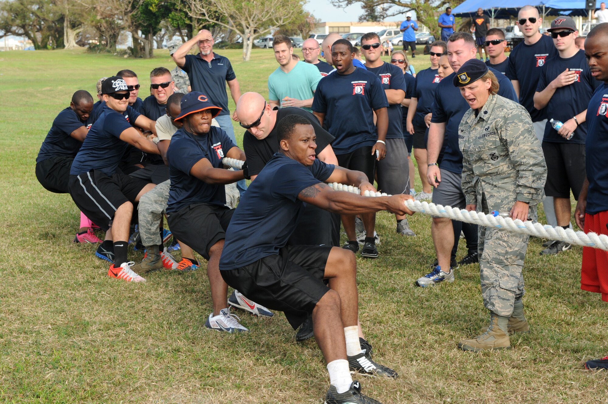 The 18th Security Forces Squadron team plays tug-of-war while being cheered on by their squadron during the 18th Mission Support Group sports day on Kadena Air Base, Japan, Oct. 24, 2014. The MSG has its sports day every year where it brings together all of the squadrons in the group and lets them battle it out in a series of sporting events throughout the day. (U.S. Air Force Photo by Airmen 1st Class Stephen G. Eigel/Released)