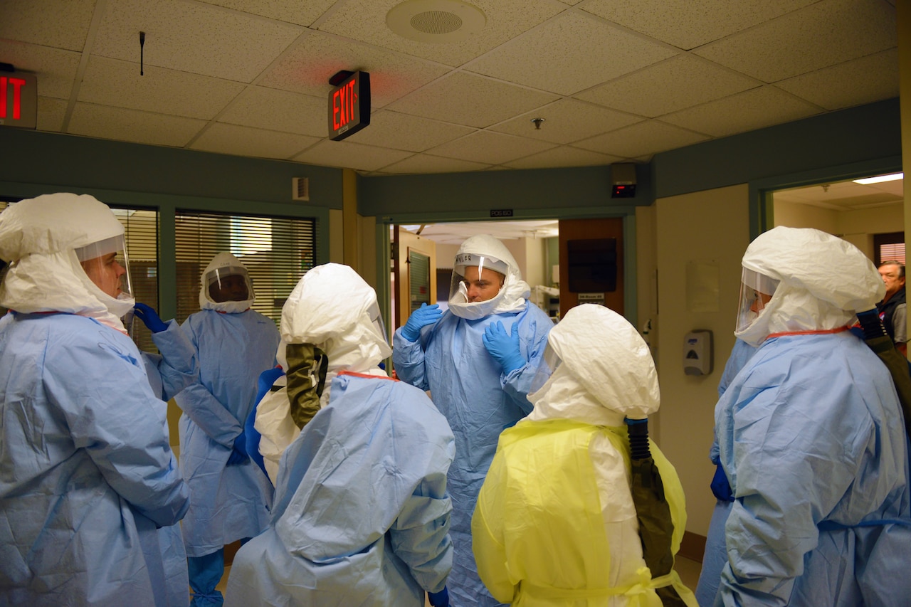 Navy Cmdr. (Dr.) James Lawler, center, an infectious disease physician, talks to team members during a training event at the San Antonio Military Medical Center on Joint Base San Antonio-Fort Sam Houston, Texas, Oct. 25, 2014. The group is part of a 30-member DoD team that could be called on to respond to new cases of Ebola in the United States. DoD photo by Army Sgt. 1st Class Tyrone C. Marshall Jr.