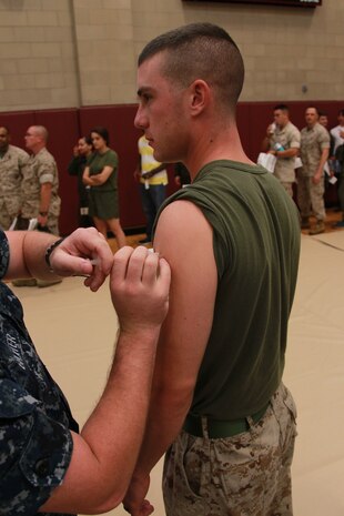 A U.S. Navy corpsman administers an influenza vaccination during Exercise Vigilant Response 2014 (VR14) aboard Marine Corps Air Station New River, N.C., Oct. 8, 2014. VR14 was a two-day exercise designed to test the ability to conduct command and control measures in response to a pandemic outbreak.