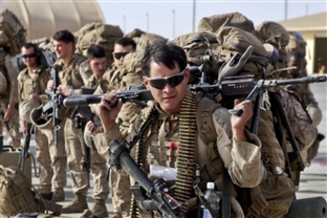 A U.S. Marine prepares to load onto a KC-130 aircraft on the Camp Bastion flightline, Afghanistan, Oct. 27, 2014. The battalion was the final Marine Corps infantry battalion to serve in Helmand province  as the Marine Corps ended its operations. The Marine is assigned to 1st Battalion, 2nd Marine Regiment.