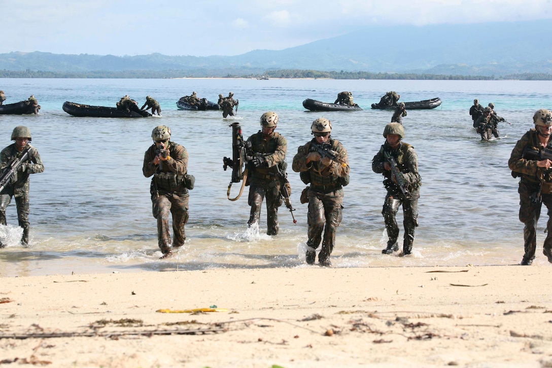 Philippine and U.S. Marines simulate an amphibious landing and beach assault on a small island off the coast of Palawan, Philippines, Oct. 2 during Amphibious Landing Exercise 2015. The amphibious assault and boat raids were conducted by U.S. Marines to complete a certification exercise being held in conjunction with PHIBLEX 15. PHIBLEX is an annual, bilateral training exercise conducted by the Armed Forces of the Philippines, U.S. Marines and Navy to strengthen interoperability across a range of capabilities, including disaster relief and contingency operations. The AFP Marines are with 12th Marine Battalion, Philippine Marine Corps, and the U.S. Marines are with Battalion Landing Team 3rd Battalion, 5th Marine Regiment, 31st Marine Expeditionary Unit. (U.S. Marine Corps photo by Sgt. Anthony J. Kirby/Released)