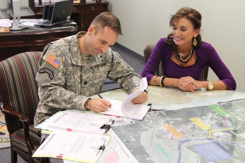 Lt. Col. John Litz signs the Record of Decision and issues the permit for the Haile Gold Mine project with Diane Garrett, President and CEO of Romarco Minerals, Inc.