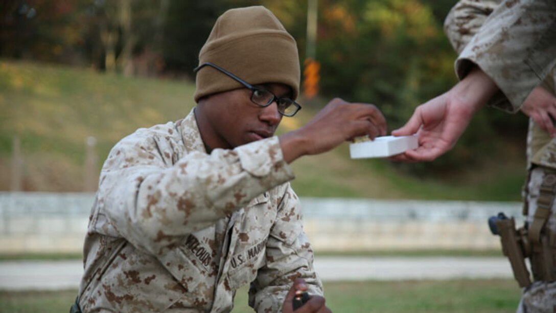 Lance Cpl. Keven Saint Louis, a marksmanship student at the Combat Marksmanship Coaches Course, loads rounds into a magazine during the pre-qualification course of fire at the Marksmanship Training Unit, Weapons Training Battalion in Quantico, Va., Oct. 24, 2014. This particular CMC course was staffed entirely by Reserve Marines from the Marine Corps Reserve Shooting Team, who are the top competitive shooters in the Marine Corps Reserve.